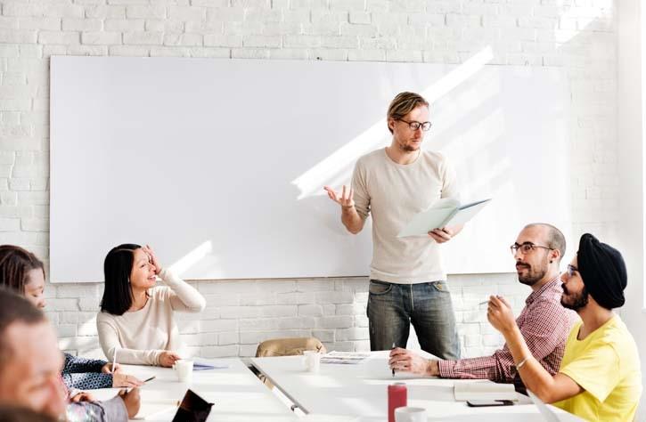 Students with teacher in classroom with whiteboard
