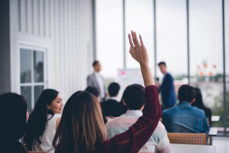 Woman raising hand in meeting