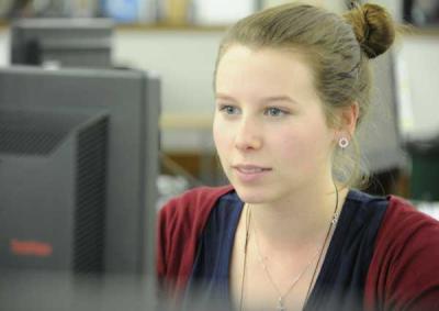 A student looks at a computer screen. 