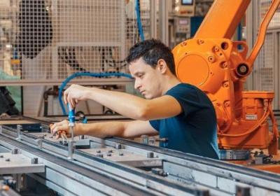 Apprentice working on machinery while undergoing apprenticeship