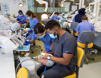 Dentist teaching dentistry students