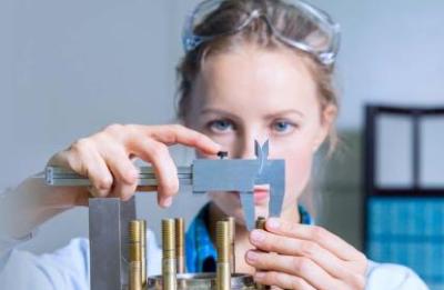 Female student in classroom applying trade measurement skills