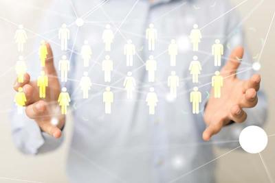 Man holding out hands with interactive figures of people appearing between them