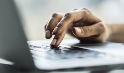 Persons hand on kepyboard clicking